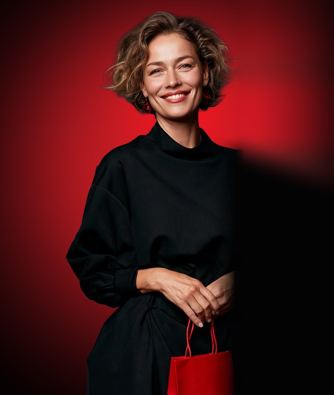 Smiling customer holding a red jewelry bag